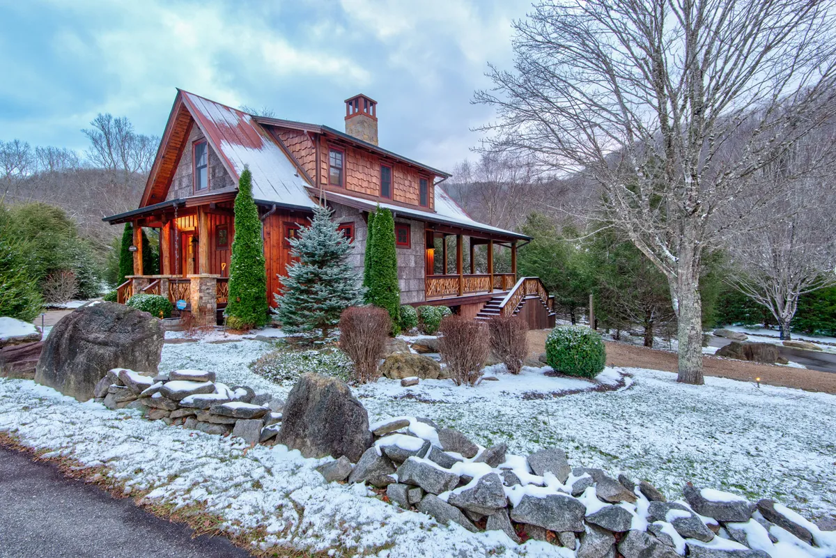 A snow-dusted landscape with the cabin and trees, a stone pathway, and a cozy porch, evoking year-round enjoyment of the outdoors. The scene suggests both adventure and warmth, with space for gathering or unwinding after a hike.